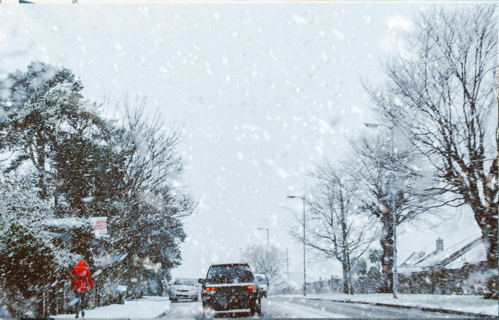 An driving on a snowy road