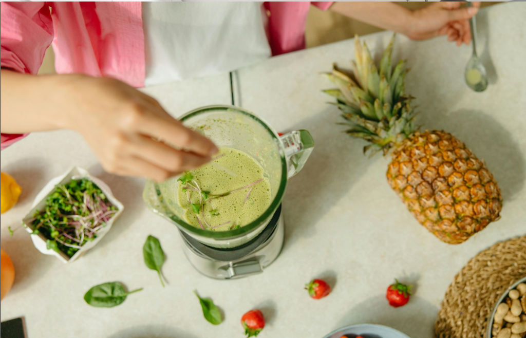 A high-tech blender with fresh ingredients next to it