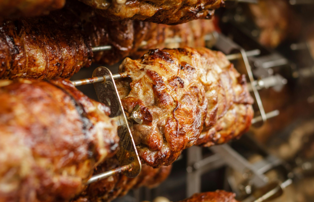 A meat thermometer inserted into a roasting steak
