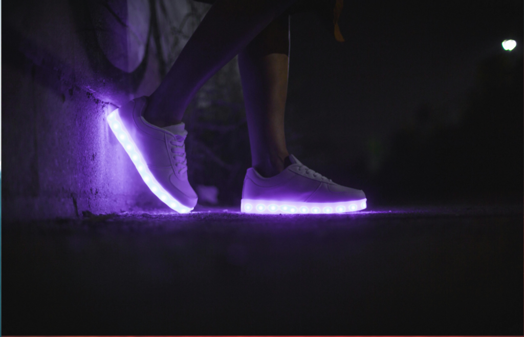 A pair of futuristic sneakers with glowing AI indicators.