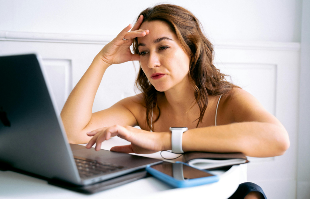 A stressed-out buyer sitting And Using Laptop