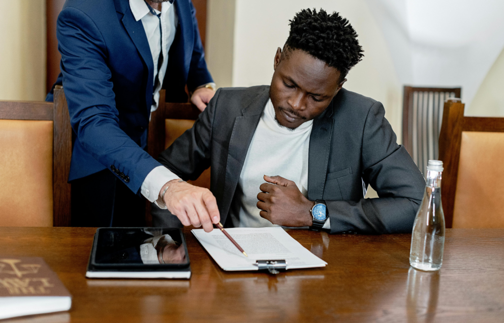 A dealer pointing at a contract with expensive add-ons listed