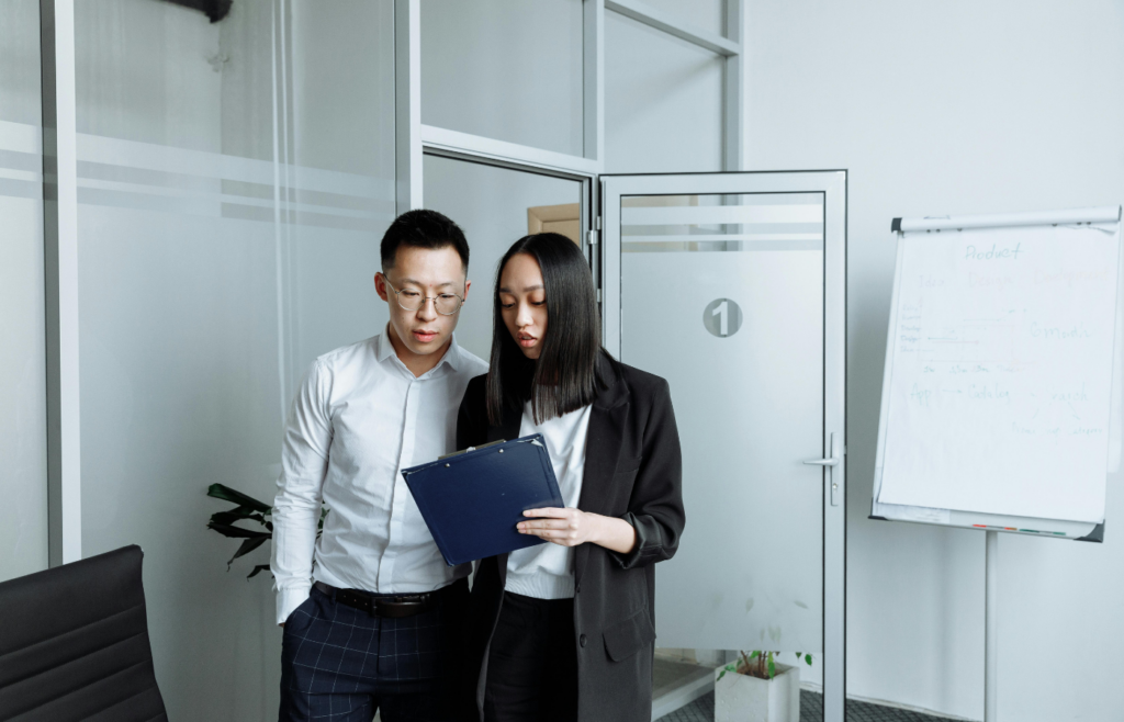 A dealer looking at a clipboard while talking up demand