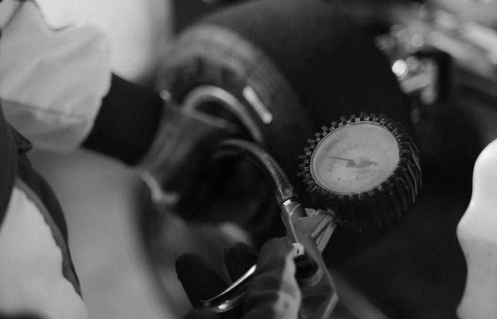 Checking Kart Tire Pressure in Black and White