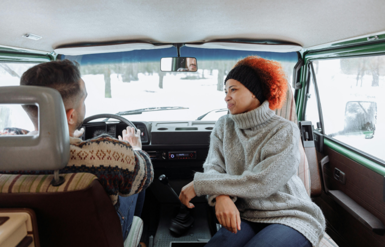 A car interior with people chatting