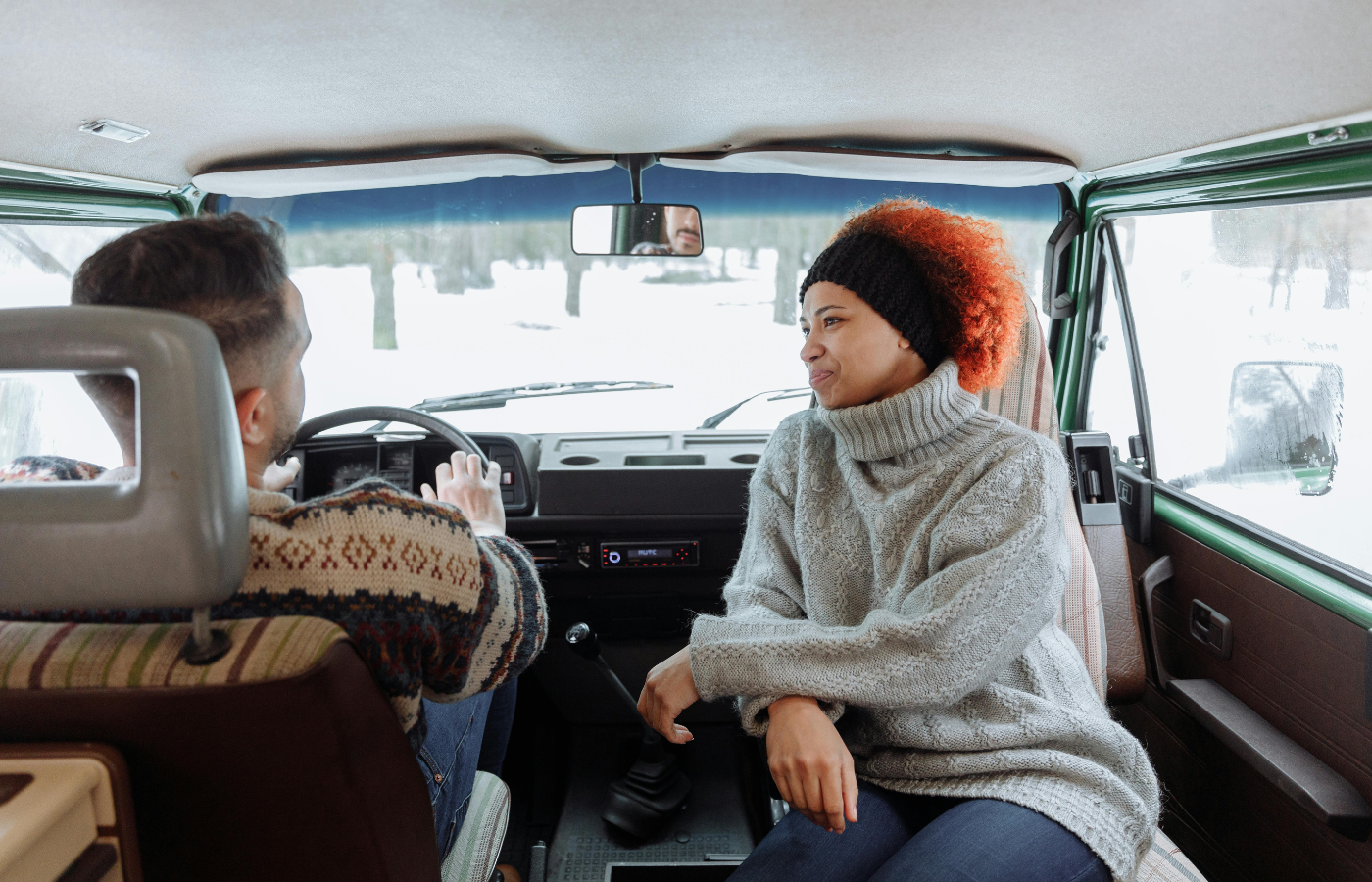 A car interior with people chatting