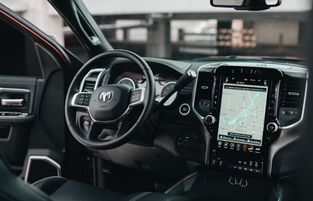 Dashboard with traditional needle gauges next to a modern digital screen