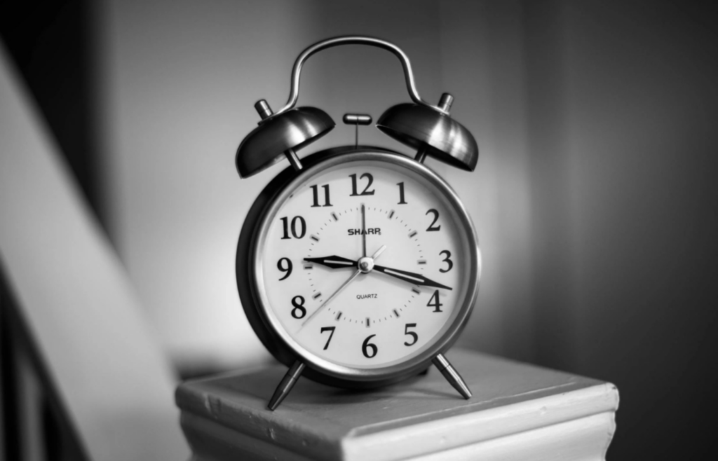 Close-up of a smart alarm clock on a bedside table