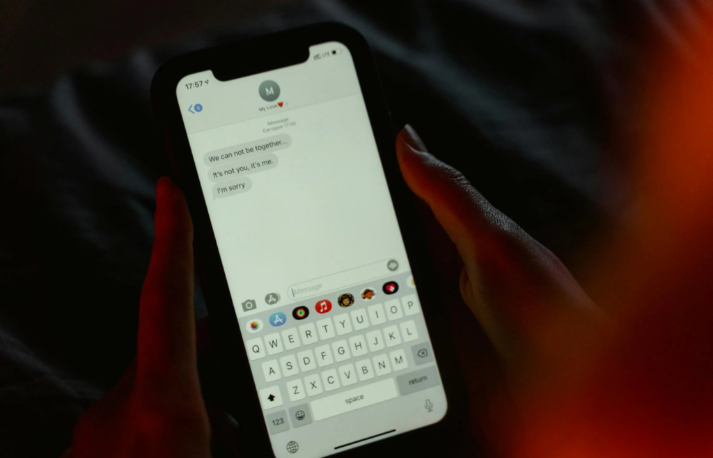 A phone lighting up with notifications at night