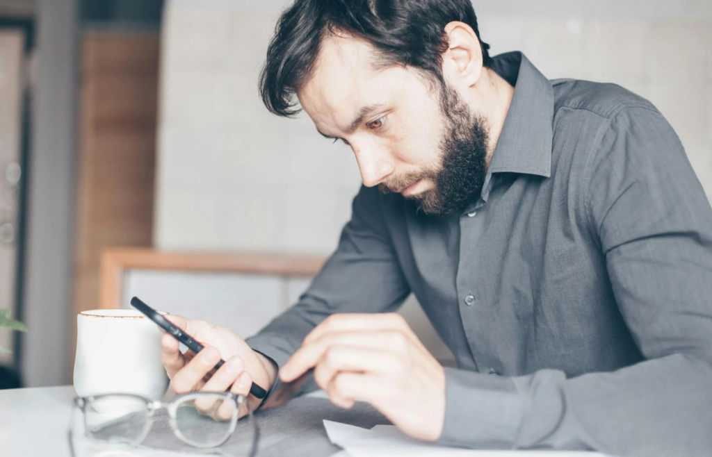 A stressed person scrolling on a phone