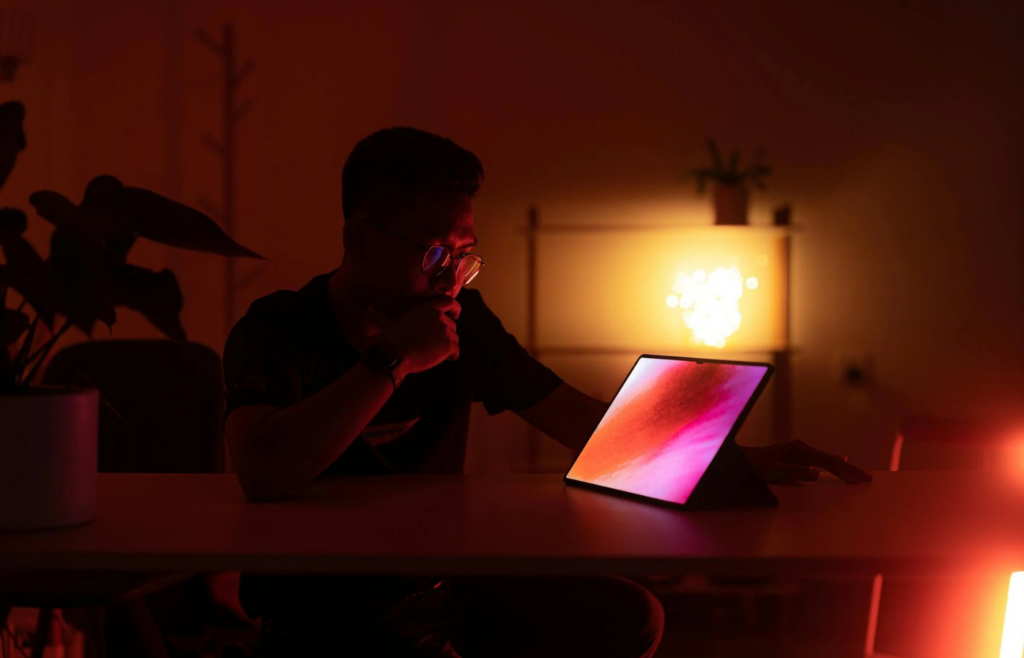 A glowing smart speaker or screen in a dark room