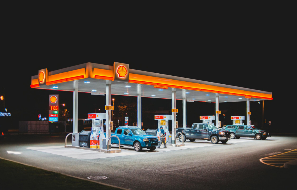 A busy gas station with multiple cars fueling up