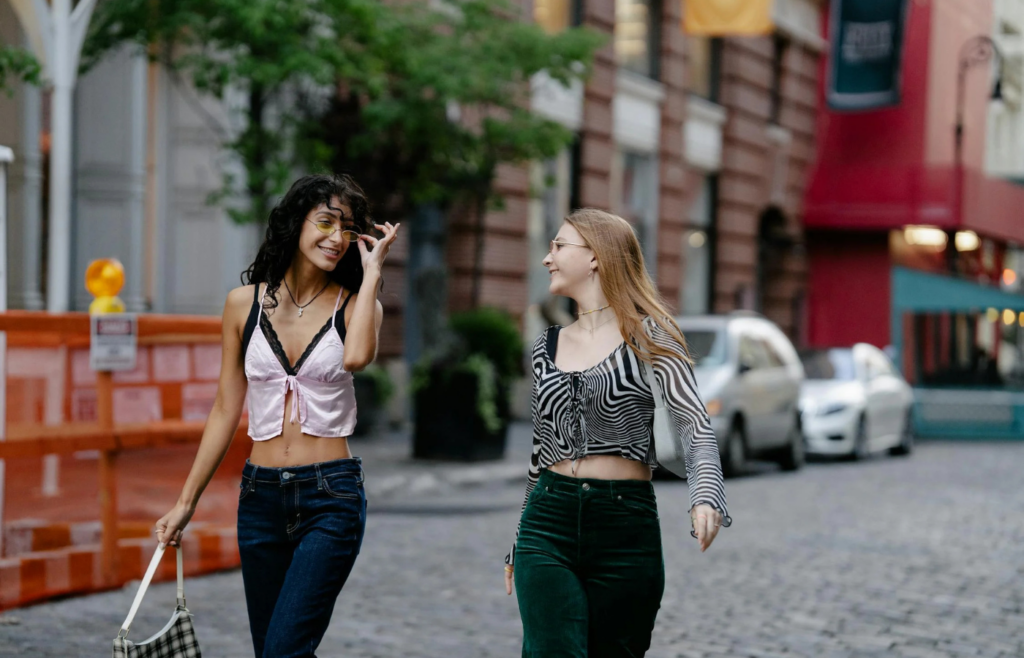Two friends walking and talking without phones