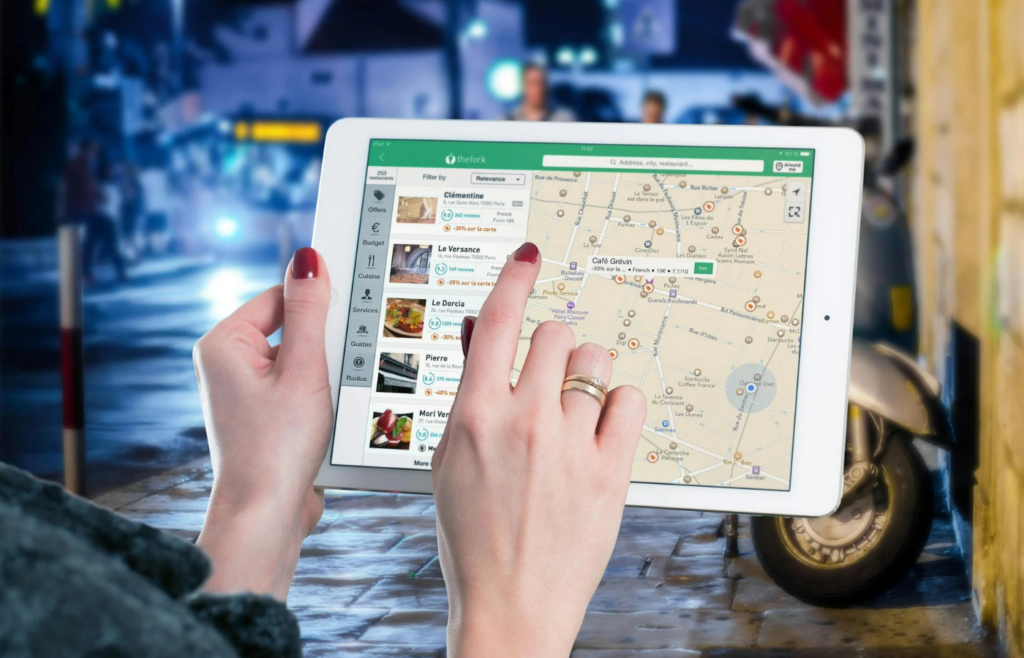 Individual using a tablet to navigate various applications