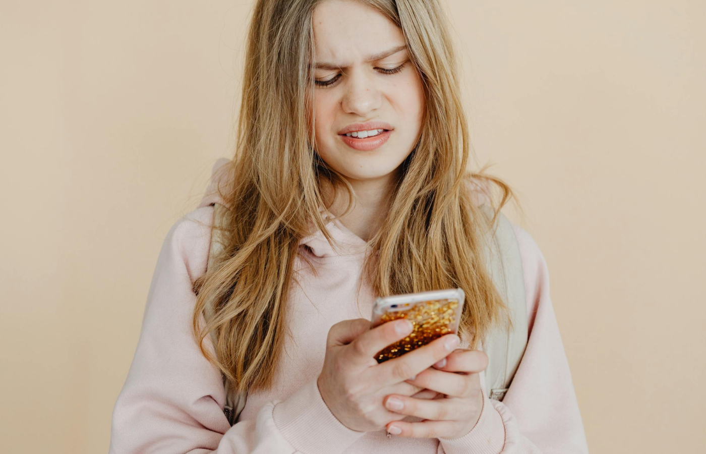 Person looking overwhelmed while holding a smartphone