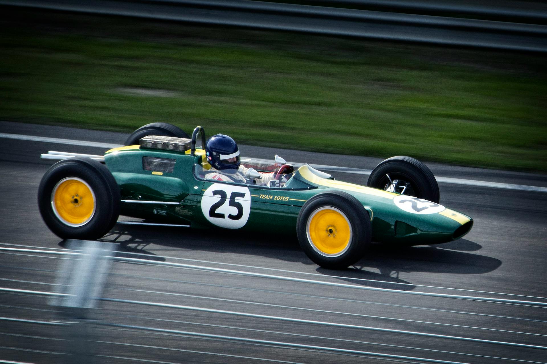 green and white racing vehicle on lane